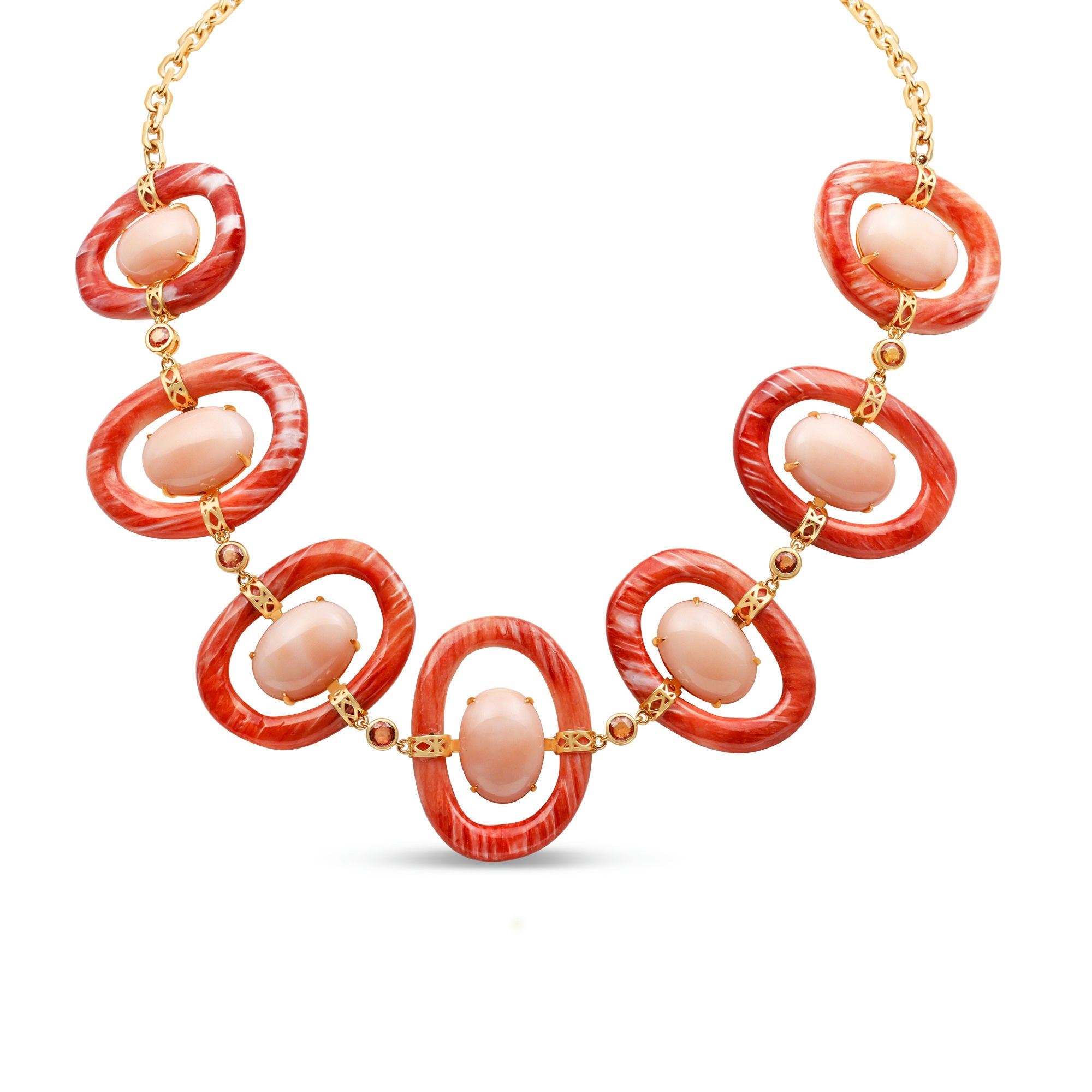 Striking 18K yellow gold link necklace featuring hand-carved orange shell links, smooth pink coral cabochons, and delicate orange sapphires, blending warm hues with masterful craftsmanship for a bold yet sophisticated statement piece. Front view of necklace.