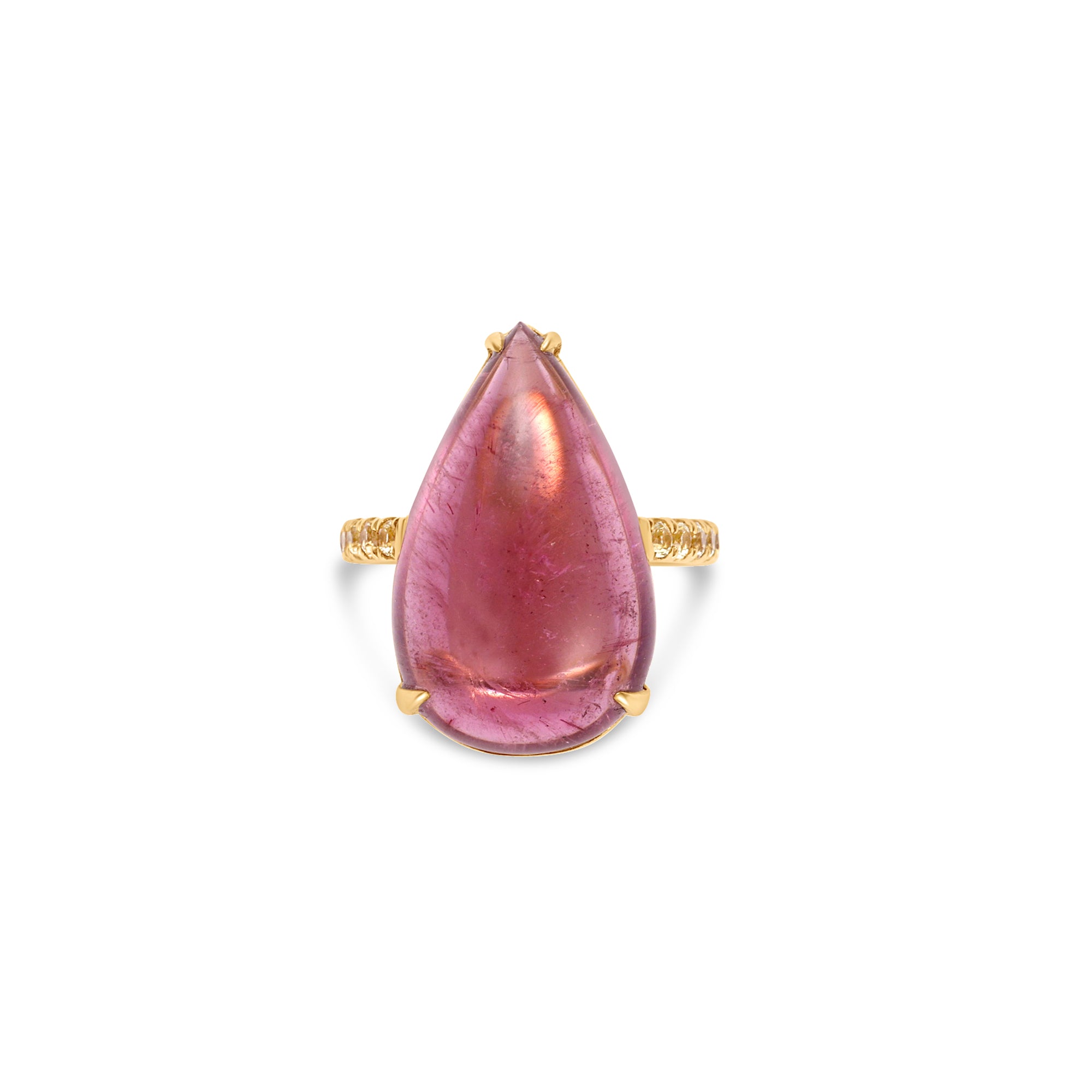 Exquisite 18K yellow gold ring featuring a breathtaking hand-carved pink tourmaline cabochon with a luminous glow, accented by vibrant yellow sapphires for a striking contrast of warmth and brilliance. Top view close up of stone and prong setting.