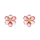 Exquisite one-of-a-kind 18K yellow gold clip-on stud earrings featuring meticulously hand-carved pink tourmaline plum blossoms, accented with sparkling diamonds for a refined and elegant floral statement. Close up front angle. 
