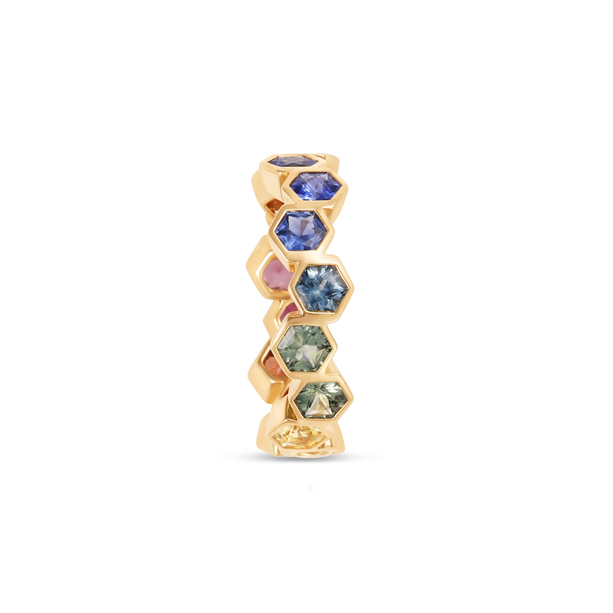 Captivating 18K yellow gold eternity ring featuring vibrant hexagon-cut sapphires in a spectrum of colors, offering a playful yet elegant touch to any jewelry collection. Side angle. 