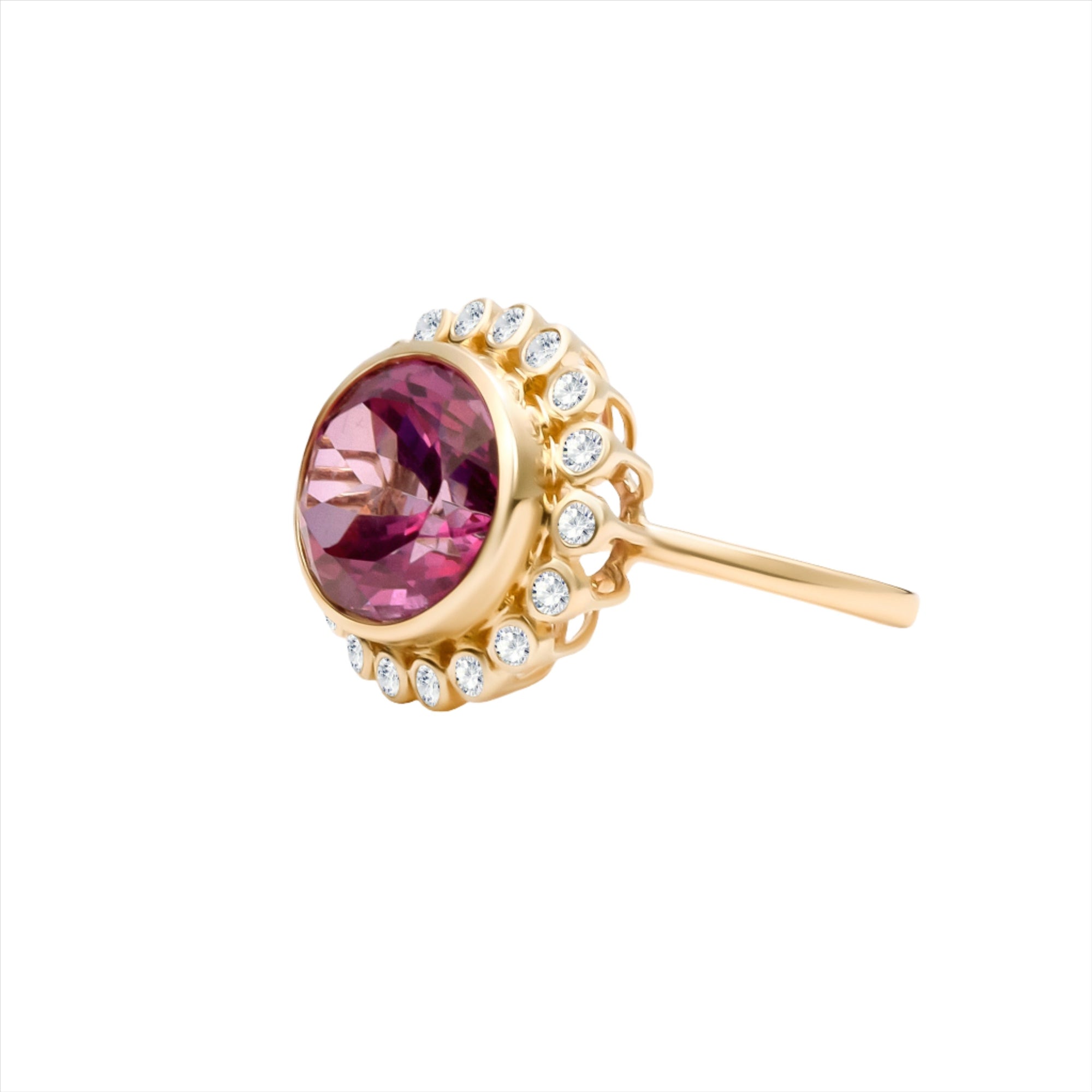 Bold 14K yellow gold cocktail ring featuring a vivid hot pink tourmaline center surrounded by a sparkling diamond halo in an elegant basket setting, designed to make a vibrant statement.