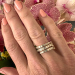 Modern wrap-around ring crafted in 14K yellow gold, featuring dazzling illusion-set baguette diamonds with clean lines and elegant craftsmanship, making it a versatile and stackable jewelry piece. Side angle front, close up.