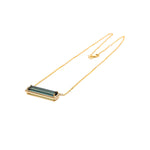 Exquisite 14K yellow gold bar necklace featuring a striking six-carat indicolite tourmaline, elegantly surrounded by a dazzling diamond halo for a timeless and eye-catching statement.