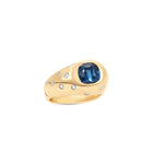 Mesmerizing 18K yellow gold ring featuring a vivid blue indicolite gemstone accented with a scattered spray of sparkling diamonds, offering timeless elegance and individuality.