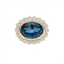 Elegant 14K yellow gold cocktail ring featuring a 10.71ct London blue topaz surrounded by a sparkling diamond halo, set in a sophisticated anemone-inspired basket design.