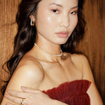 Chic 14K yellow gold choker featuring marquise-cut diamonds with delicate dangling accents, offering understated glamour and a modern twist for sophisticated styling. On body shot
