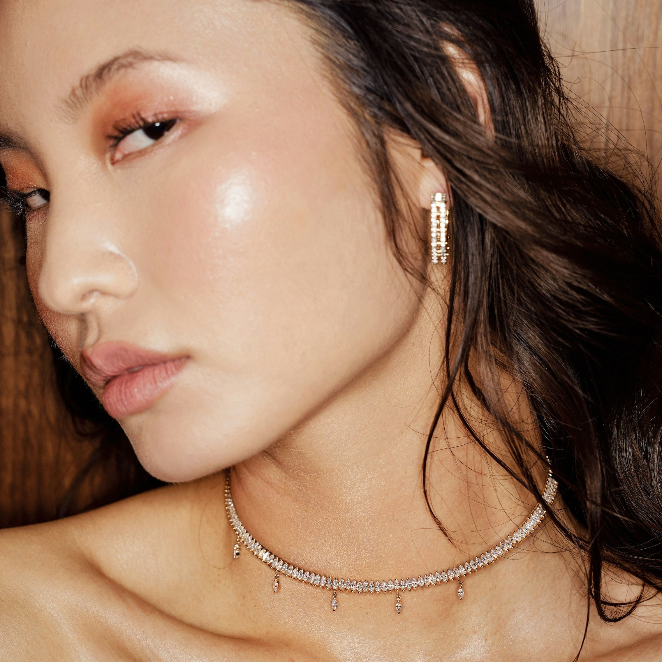Chic 14K yellow gold choker featuring marquise-cut diamonds with delicate dangling accents, offering understated glamour and a modern twist for sophisticated styling. On body shot