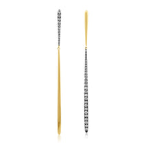 Stylish mismatched drop earrings crafted in 14K yellow and white gold, featuring sleek straight-line bar designs with alternating diamond accents for a unique and modern contrast. Close up. 