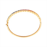 Striking 14K yellow gold bangle featuring a radiant array of multi-colored sapphires totaling 15.72ct. Weighing 12.21g, this bold and colorful bracelet brings playful elegance to any look.