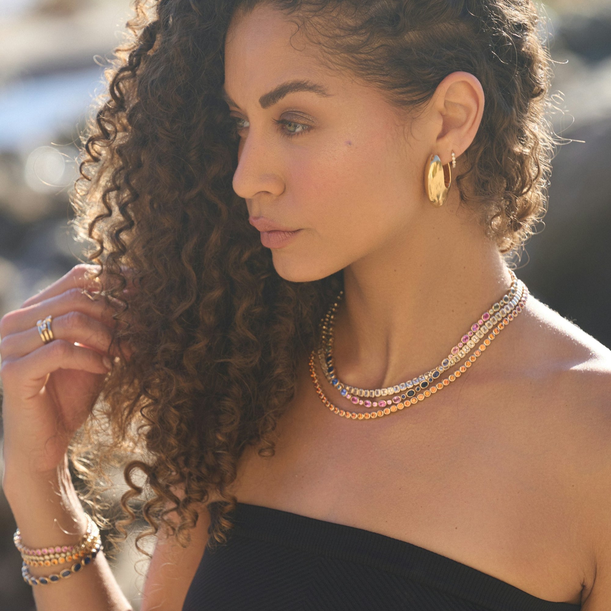 Vibrant 14K yellow gold necklace featuring a perfectly matched suite of alternating oval and round cut sapphires in multi-colored hues, totaling 23.85ct across a 16-inch chain and weighing 24.53g.
