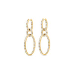 Luxurious multi-tier oval hoop earrings crafted in 14K yellow gold, featuring dazzling round diamonds set within elegant oval shapes, offering graceful movement and timeless sophistication. Side view close up. 