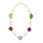 Statement necklace featuring freeform aqua, yellow beryl, pink tourmaline, and peridot gemstones with 8.36ct of D-color VVS1 diamonds, set in 118g of 18K yellow gold with adjustable length.