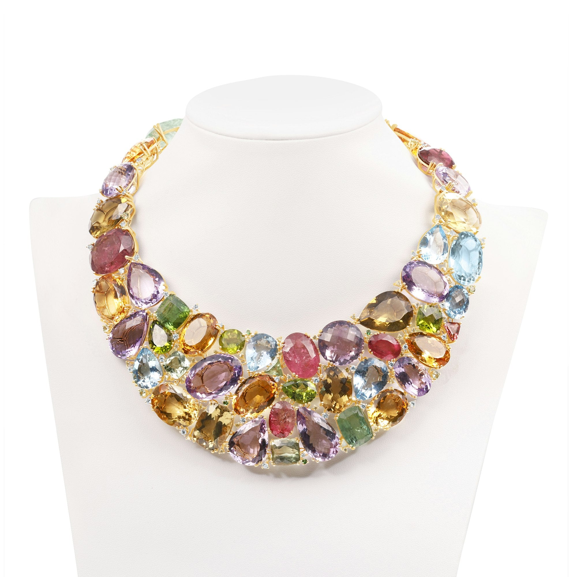 Extraordinary one-of-a-kind bib necklace crafted in 18K yellow gold, featuring a dazzling mosaic of semi-precious gemstones including amethyst, citrine, peridot, topaz, and tourmaline, designed to make a bold and elegant statement.