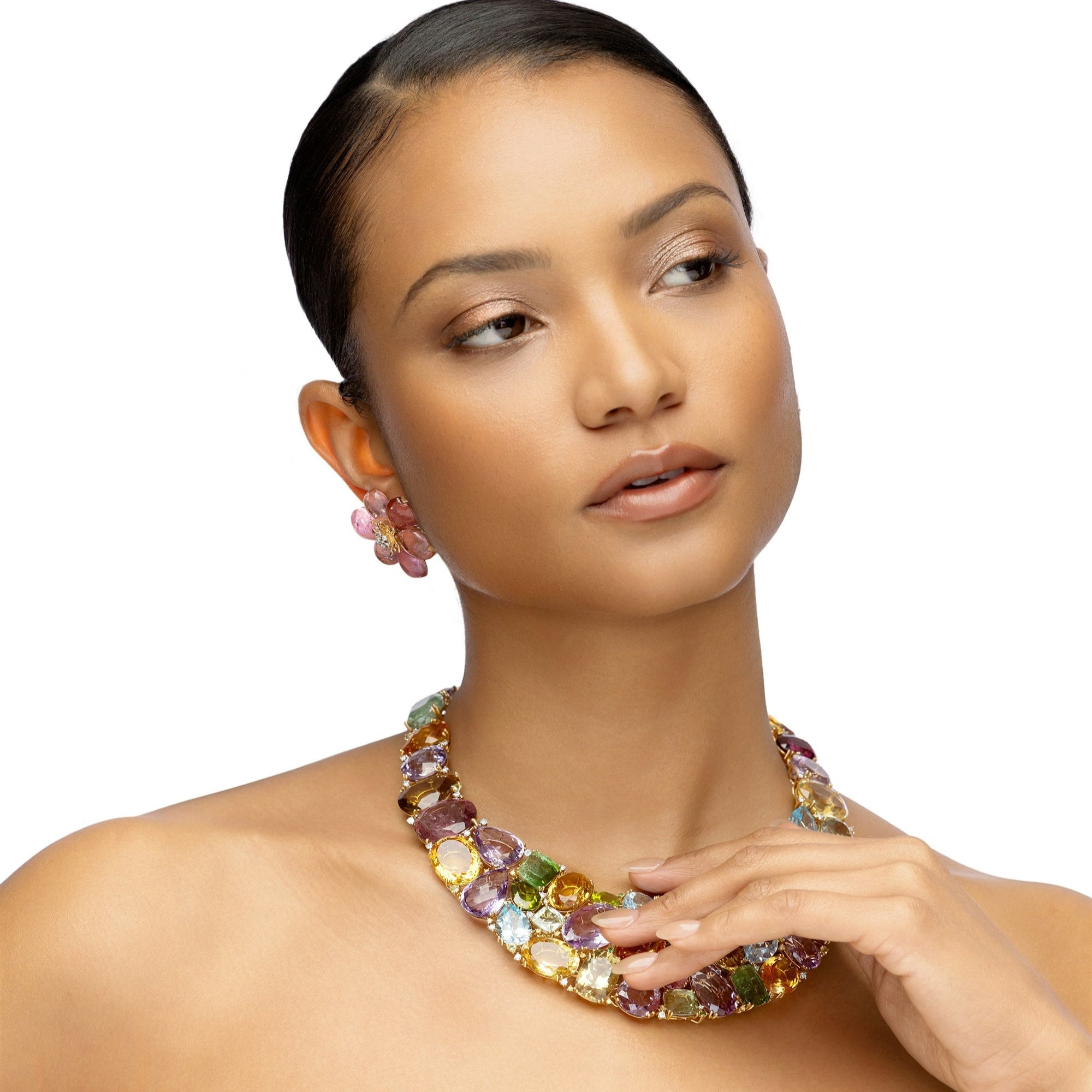 Extraordinary one-of-a-kind bib necklace crafted in 18K yellow gold, featuring a dazzling mosaic of semi-precious gemstones including amethyst, citrine, peridot, topaz, and tourmaline, designed to make a bold and elegant statement.