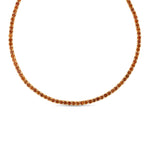 Elegant 14K yellow gold tennis necklace featuring a stunning array of vibrant orange sapphires, highlighting their radiant beauty with exceptional craftsmanship and bold sophistication.