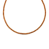Elegant 14K yellow gold tennis necklace featuring a stunning array of vibrant orange sapphires, highlighting their radiant beauty with exceptional craftsmanship and bold sophistication.
