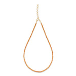 Elegant 14K yellow gold tennis necklace featuring a stunning array of vibrant orange sapphires, highlighting their radiant beauty with exceptional craftsmanship and bold sophistication. 