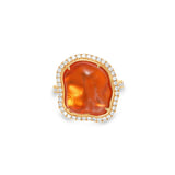 Captivating 18K rose gold ring featuring a glowing 6.21ct organic fire opal cabochon, encircled by a shimmering 0.51ct diamond halo for a radiant and enchanting statement piece. Close up detail.