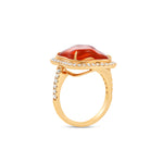 Captivating 18K rose gold ring featuring a glowing 6.21ct organic fire opal cabochon, encircled by a shimmering 0.51ct diamond halo for a radiant and enchanting statement piece. Side view. 