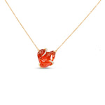 Captivating 18K rose gold pendant necklace featuring a free-form organic fire opal with vibrant red hues, accented by sparkling diamond prongs for a one-of-a-kind elegant masterpiece. Close up view.