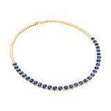 Stunning 14K yellow gold tennis necklace featuring 15.5ct of royal blue oval sapphires and 64 round 2.5mm solitaire diamonds, totaling 16 inches in length—a timeless and regal gemstone piece.