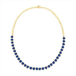 Stunning 14K yellow gold tennis necklace featuring 15.5ct of royal blue oval sapphires and 64 round 2.5mm solitaire diamonds, totaling 16 inches in length—a timeless and regal gemstone piece.
