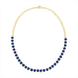 Stunning 14K yellow gold tennis necklace featuring 15.5ct of royal blue oval sapphires and 64 round 2.5mm solitaire diamonds, totaling 16 inches in length—a timeless and regal gemstone piece.