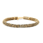 Modern slinky bracelet crafted in sleek 14K yellow Italian gold, featuring sparkling pavé black diamond rondelles for a bold and unique statement of elegance. Close up with clasp open