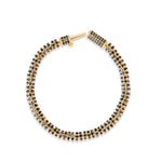 Modern slinky bracelet crafted in sleek 14K yellow Italian gold, featuring sparkling pavé black diamond rondelles for a bold and unique statement of elegance. Open clasp top down image