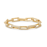 Timeless paperclip bracelet crafted in 14K yellow gold, featuring oblong links adorned with sparkling pavé diamonds, perfect for adding elegance to any outfit.