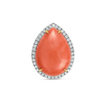 Stunning 18K yellow gold statement ring featuring a captivating pear-shaped coral cabochon, elegantly framed by a halo of brilliant diamonds, blending natural warmth with luxurious sparkle. Front view of stones. 