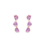 Dazzling pink sapphire drop earrings featuring three luminous sapphires totaling approximately 2ct, elegantly set in 14K yellow gold for a timeless blend of charm and sophistication. Front view, close up. 