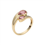 Chic 14K yellow gold bypass ring featuring two vibrant pear-shaped pink tourmalines totaling 1.45ct, designed with a graceful silhouette for a modern pop of color.