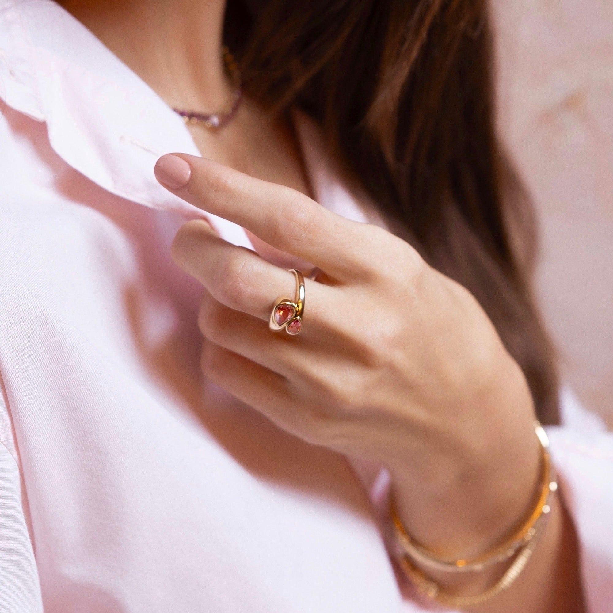 Chic 14K yellow gold bypass ring featuring two vibrant pear-shaped pink tourmalines totaling 1.45ct, designed with a graceful silhouette for a modern pop of color.