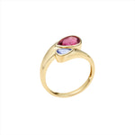 Elegant 14K yellow gold bypass ring featuring a vibrant 1.4ct pink tourmaline and a striking 0.5ct iolite gemstone, offering a bold yet graceful contrast of color and design.