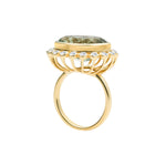 Elegant 14K yellow gold cocktail ring featuring an 8.17ct prasiolite (green amethyst) surrounded by a delicate diamond halo, set in a sophisticated basket setting for a refined statement look.