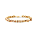 Stunning orange sapphire tennis bracelet featuring round bezel-set sapphires in 14K gold, offering a bold yet elegant statement of luxury.