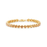 Stunning orange sapphire tennis bracelet featuring round bezel-set sapphires in 14K gold, offering a bold yet elegant statement of luxury.