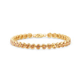 Stunning orange sapphire tennis bracelet featuring round bezel-set sapphires in 14K gold, offering a bold yet elegant statement of luxury.