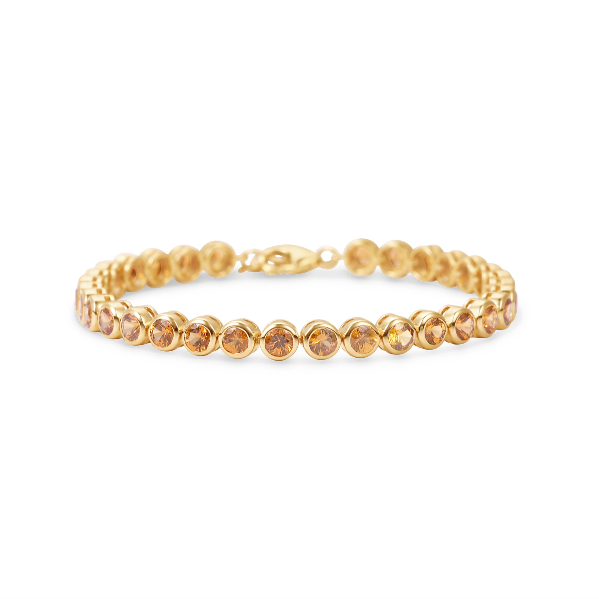 Stunning orange sapphire tennis bracelet featuring round bezel-set sapphires in 14K gold, offering a bold yet elegant statement of luxury.