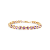Charming pink sapphire tennis bracelet featuring vibrant round bezel-set sapphires in 14K yellow gold, designed for elegance and romance.