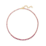 Elegant 14K yellow gold tennis necklace featuring vibrant round-cut pink sapphires in secure bezel settings, offering timeless beauty with a modern edge. Full view.
