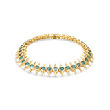 Striking 14K yellow gold bracelet featuring bezel-set vibrant emeralds in edgy, spiked links, blending modern sophistication with a bold, daring aesthetic.