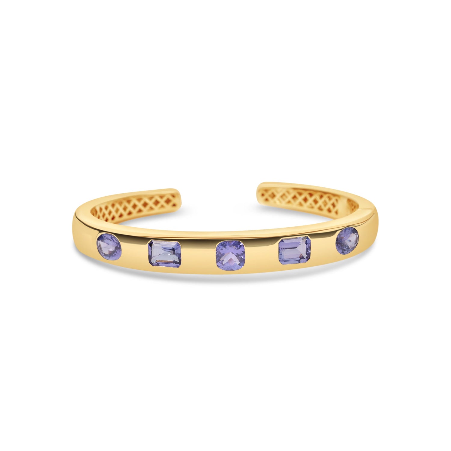 Five-stone bangle in 14K yellow gold featuring approximately 6 carats of mixed-shape tanzanite, flush-set in a polished solid gold cuff.