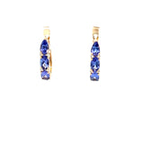 Luxurious tanzanite huggie earrings featuring vibrant gemstones in an elegant and versatile design, perfect for adding a pop of color to any outfit.