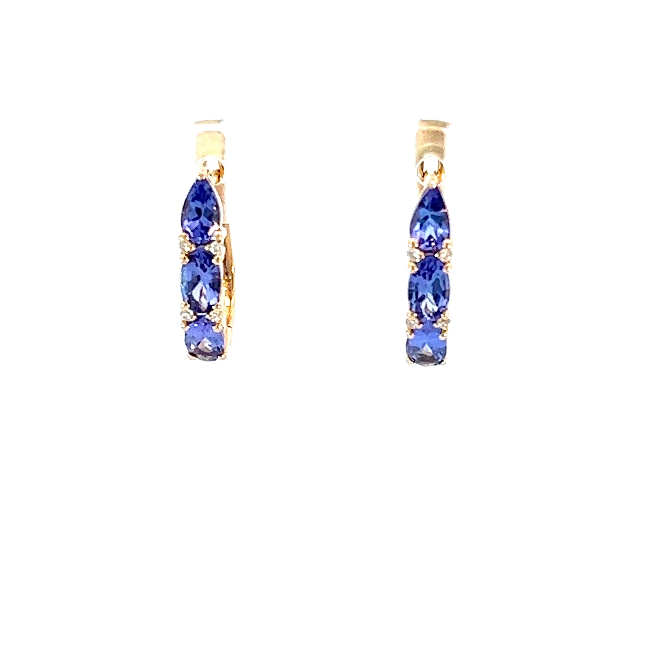 Luxurious tanzanite huggie earrings featuring vibrant gemstones in an elegant and versatile design, perfect for adding a pop of color to any outfit.