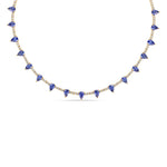 Elegant 14K yellow gold tennis necklace featuring a delicate diamond chain adorned with vibrant pear-shaped blue sapphires, offering an adjustable 15" to 17" fit for timeless sophistication. Close up. 