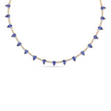 Elegant 14K yellow gold tennis necklace featuring a delicate diamond chain adorned with vibrant pear-shaped blue sapphires, offering an adjustable 15" to 17" fit for timeless sophistication. Close up. 