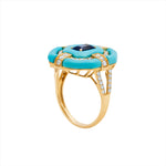 Bold 14K yellow gold cocktail ring featuring 9ct of hand-carved turquoise, a 0.75ct elongated emerald-cut sapphire, and 0.6ct of G-H VS diamonds in a striking Art Deco design.
