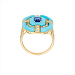 Bold 14K yellow gold cocktail ring featuring 9ct of hand-carved turquoise, a 0.75ct elongated emerald-cut sapphire, and 0.6ct of G-H VS diamonds in a striking Art Deco design.